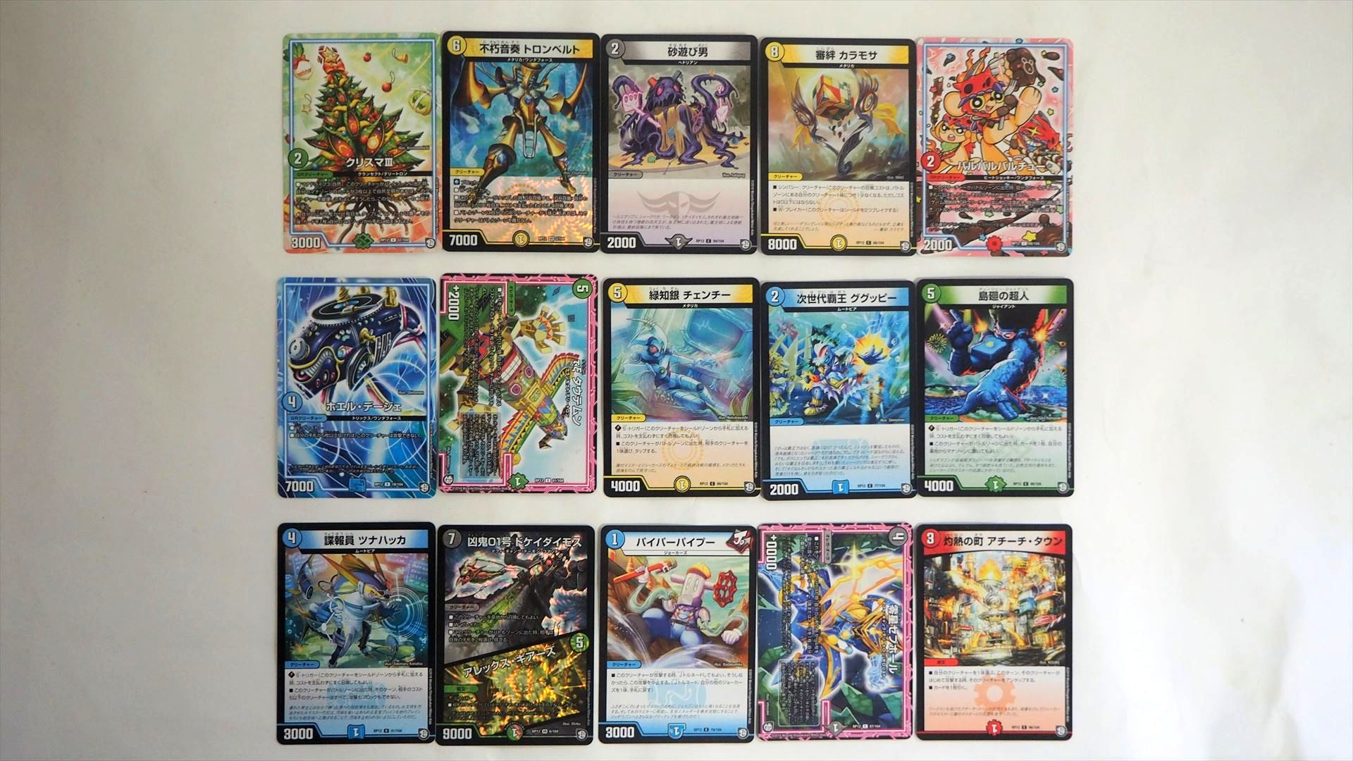 同じパックから出たカードを横に並べてみた。パックの中身はバラバラだ。この中では一番上の列の左から2つめの「不朽音奏 トロンベルト」と一番下の列の左から2つめの「凶鬼01号 ドケイダイモス/アレックス・ギアーズ」がベリーレアである。3パックでベリーレア2枚というのは悪くない引きだ