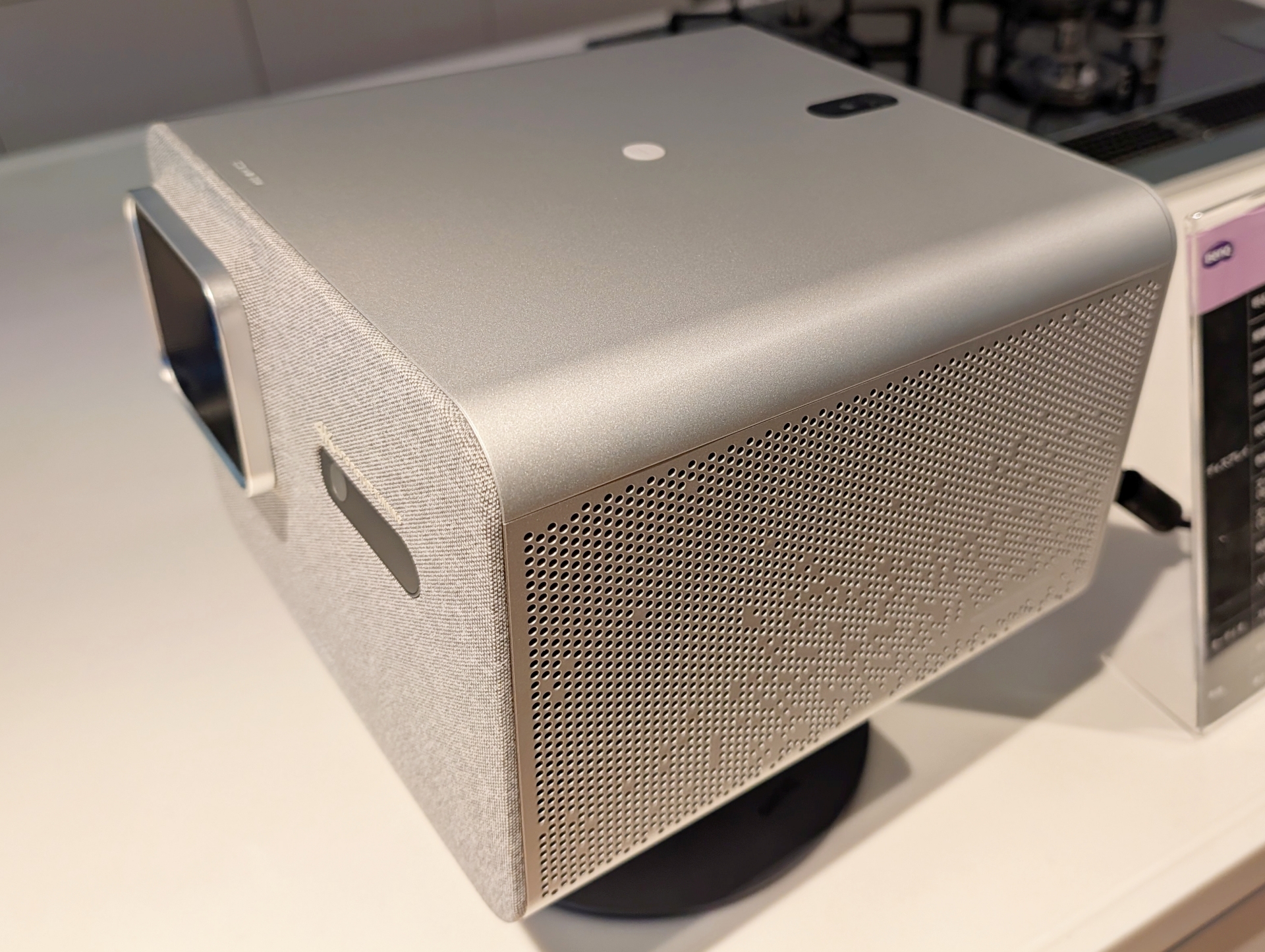 会場では「TK705STi」と形状や内部パーツは同じながら、搭載レンズを0.8倍の単焦点レンズから、1.0～1.3倍の光学ズームレンズに変更し、投射距離が異なる「TK705i」も展示されていた