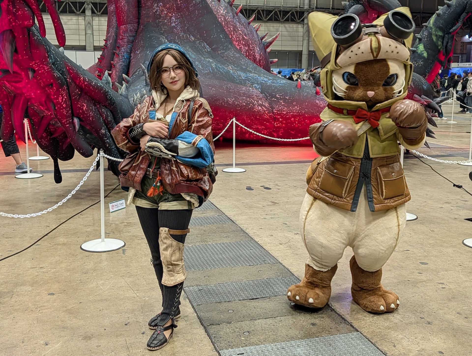 最後に超リアルな造作……ではなく、こちらは「モンハンワイルズ」の受付嬢「アルマ」のコスプレをした生身のモデルさんがアイルーとともにお出迎えしてくれた