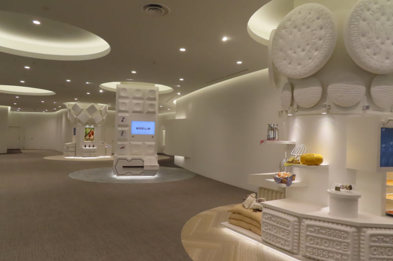 手前からビスケット（マリーなど）、アイス（チョコモナカジャンボなど）、チョコレート（DARSなど）といった商品のコーナーがあり、それぞれの商品へのこだわりを教えてくれる