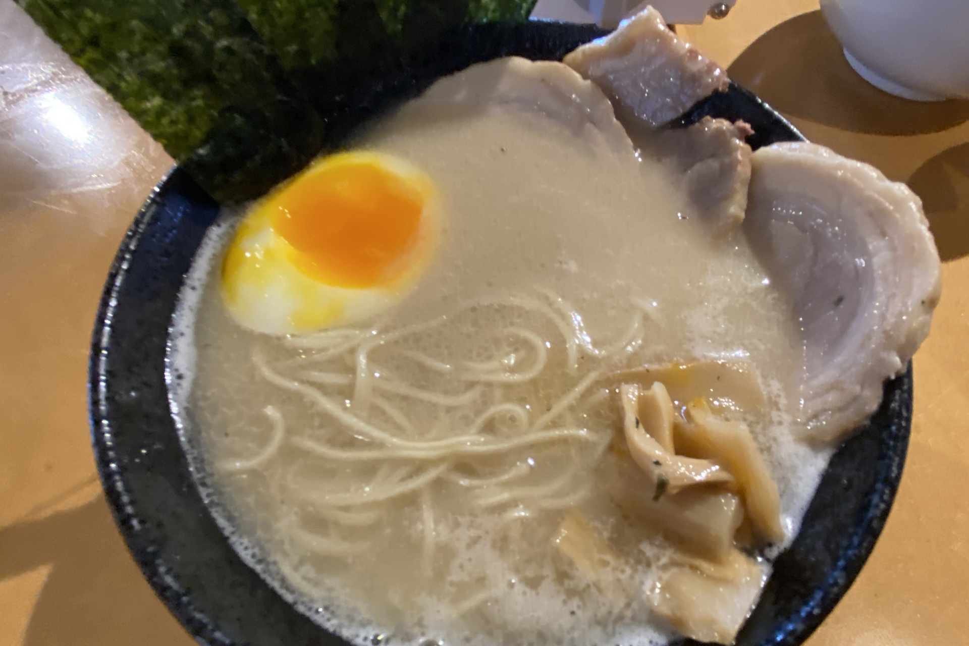 豚骨の食欲をそそる香りが作っているそばからただよう。好みでコショウをかけて味変できる