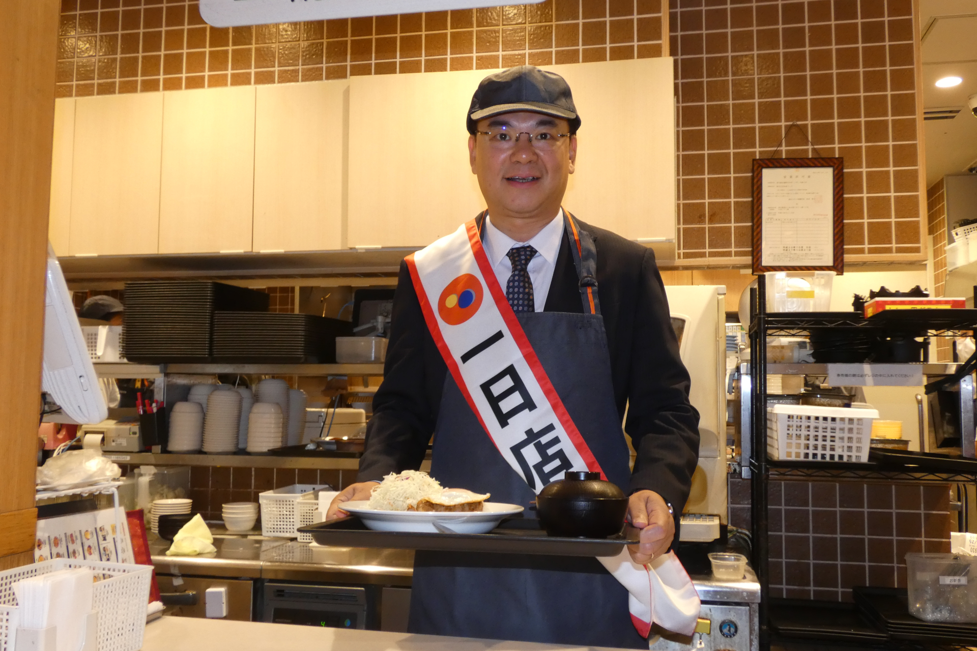 1日店長として「コムタム風ポークライス」を提供するベトナム社会主義共和国 特命全権大使のファム・クアン・ヒエウ閣下