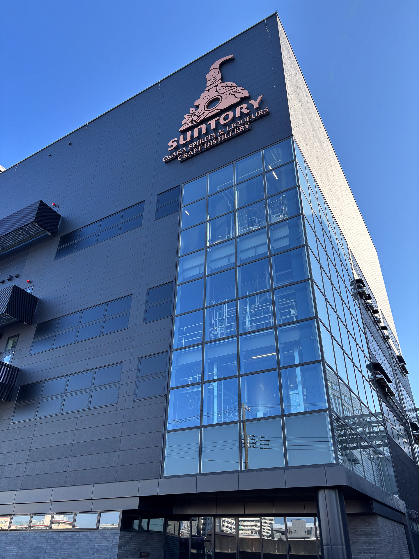 「スピリッツ・リキュール工房」の外観が一部ガラス張りになっており、外からも蒸溜釜などの姿が見える。複数のフロアの高さを活かして工程を構築している