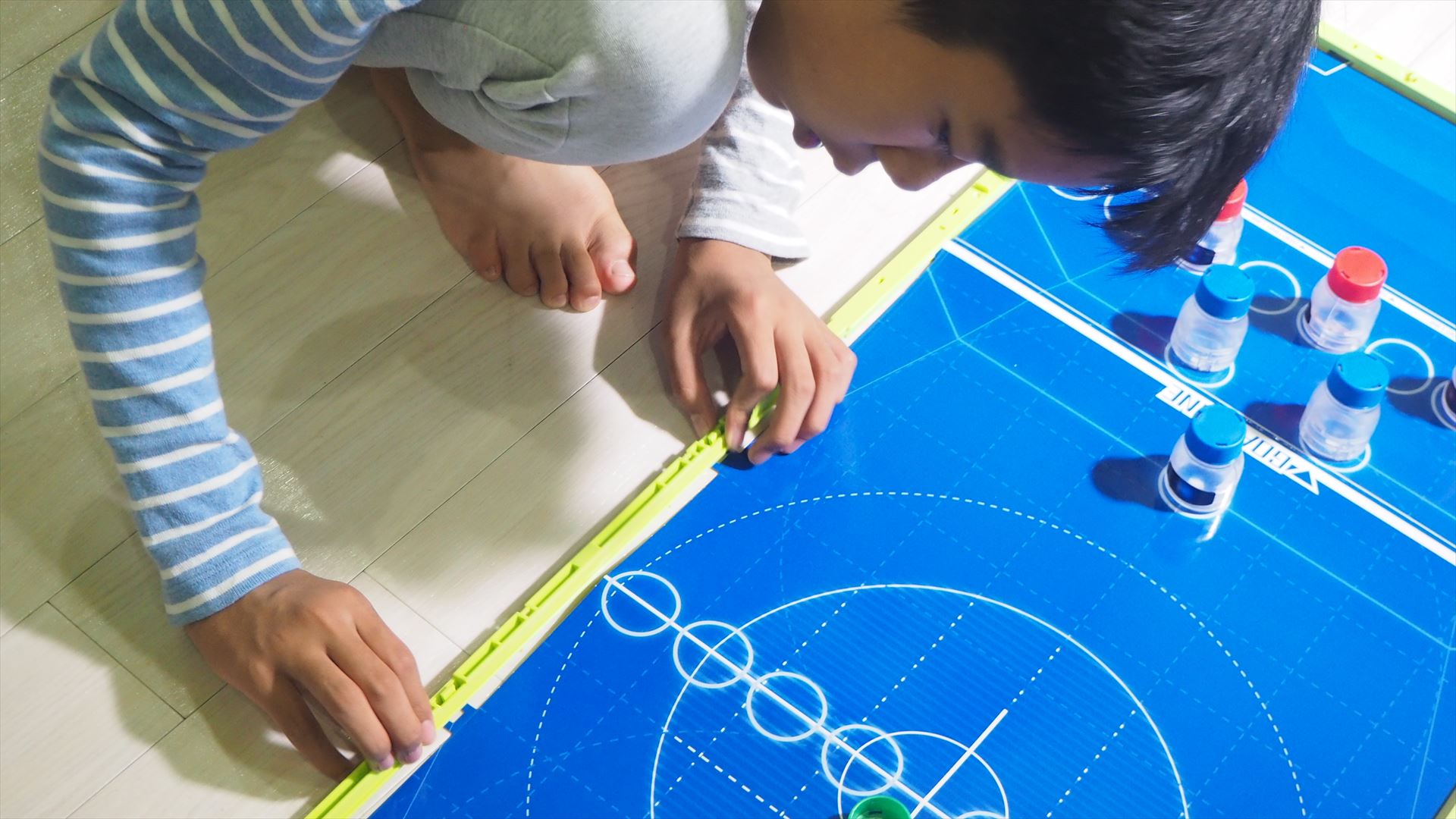 フィールドシートを広げ、周りにフィールドフェンスを設置し、バトルフィールドを組み立てる