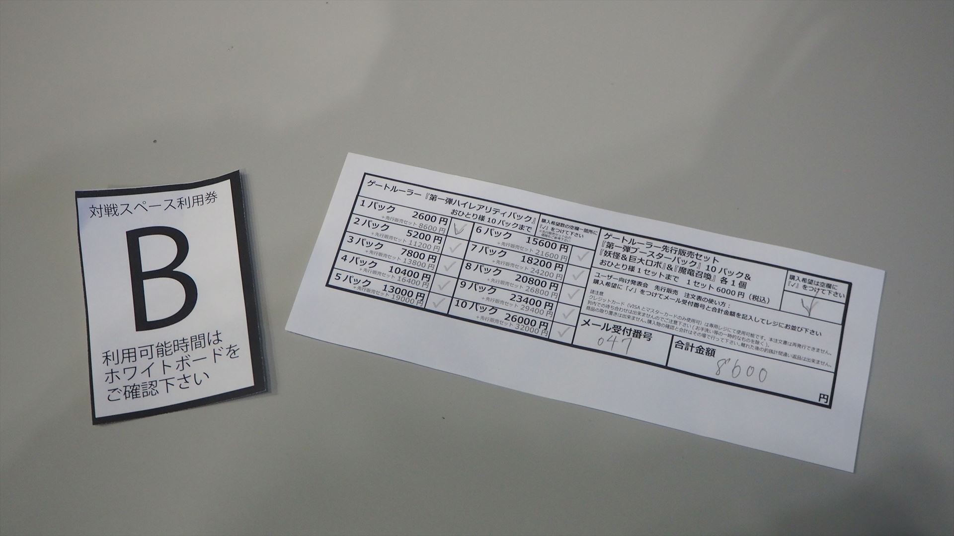 先行販売セットの申し込み書と、対戦スペース利用券を受けとる。最大でブースターパック10パックとスターターデッキ2種1個ずつ、ハイレアリティパックを10パックまで購入できる
