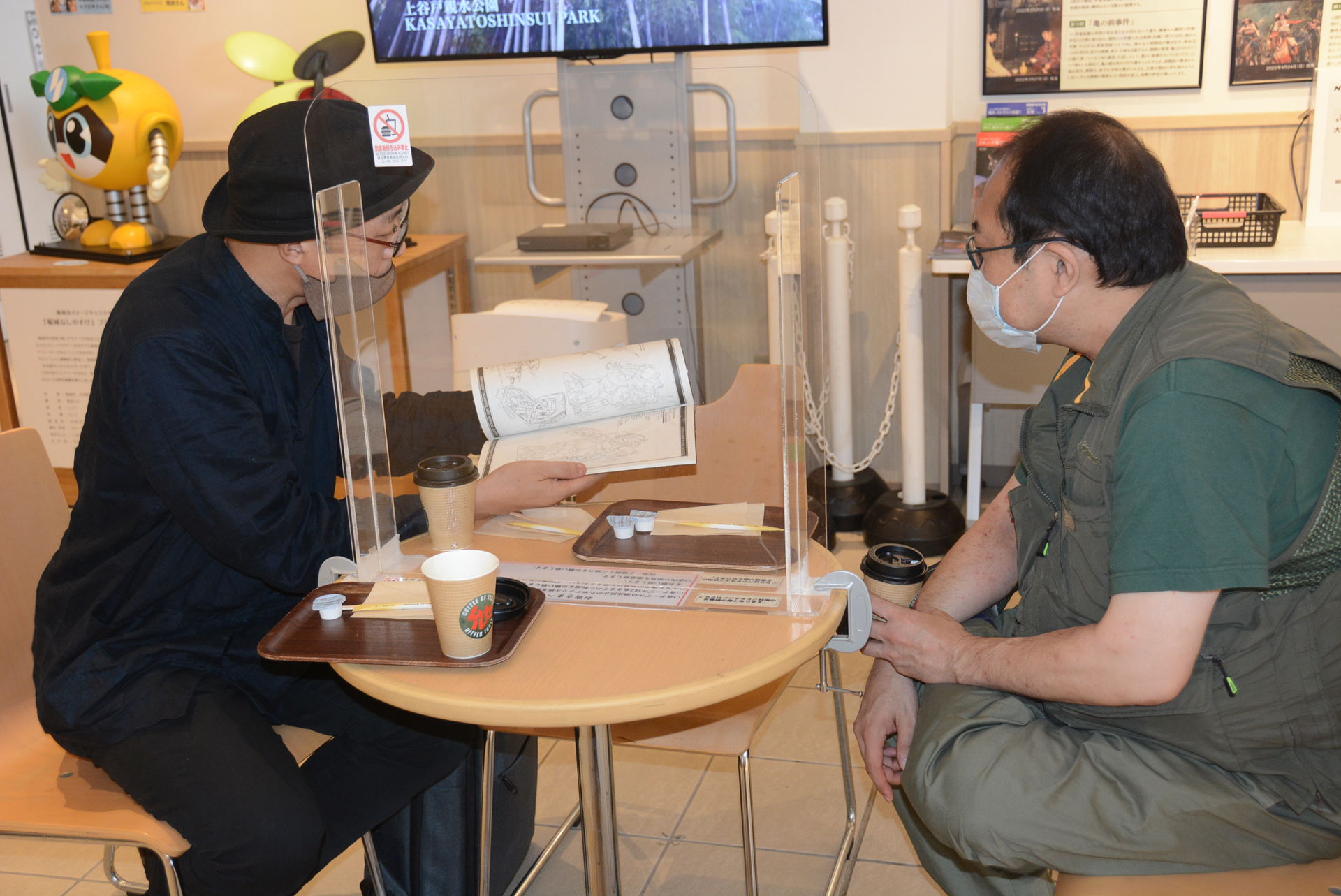 「資料集を拡げて、話している風でお願いします」。筆者の頼みにポーズをとってくれる2人が嬉しい