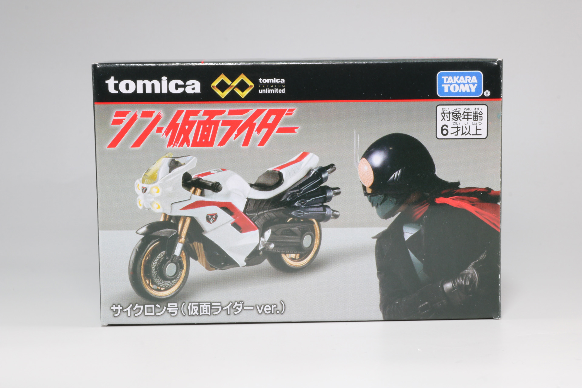 正面はコートを纏った仮面ライダーの横顔と「トミカプレミアムunlimited シン･仮面ライダー サイクロン号（仮面ライダーver.）」が描かれている