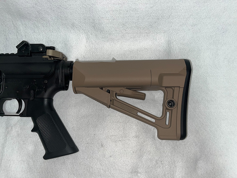 ストックはシールドリリースラッチを押し上げるとロックが外れ、最短750mm～最長825mmの調節が可能に