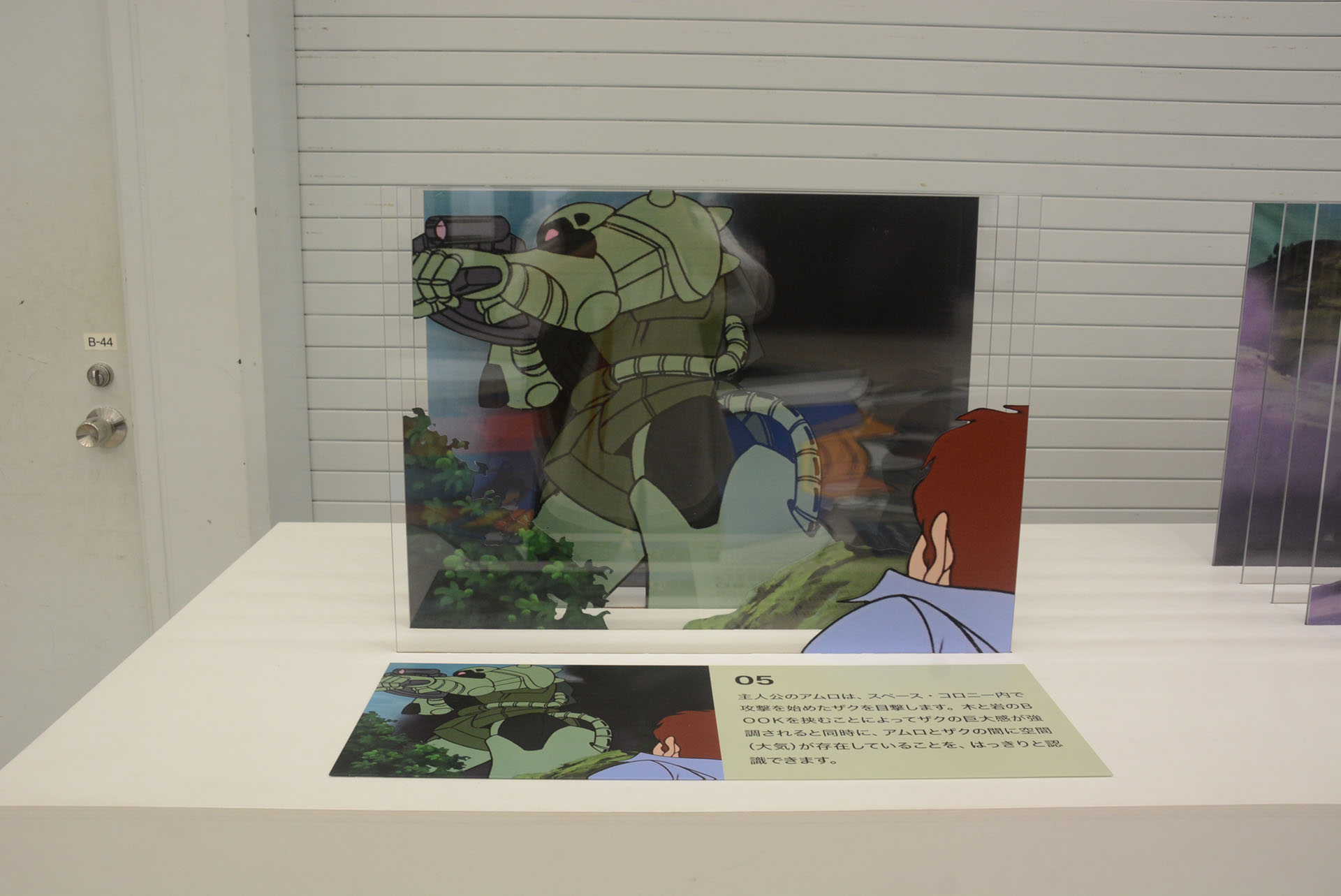 アニメ第一話のセル画を立体的に展示。レイヤーの分け方に"リアル"にこだわる視点が垣間見える