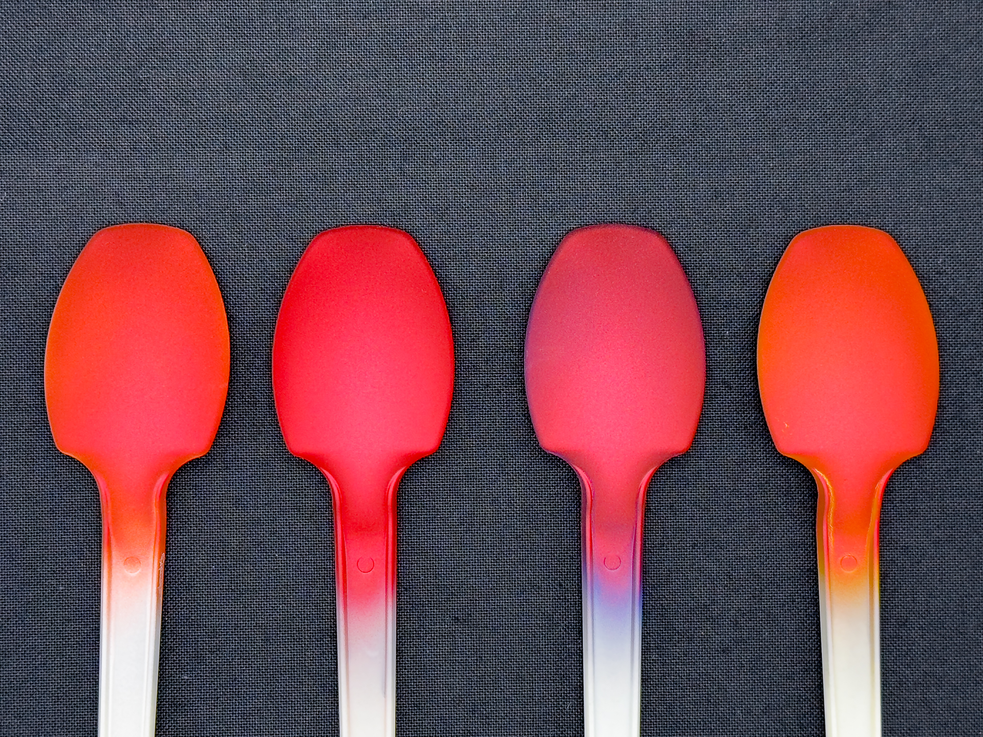 「ベルベットレッド」の発色変化。下地色は左から白、赤、青、黄