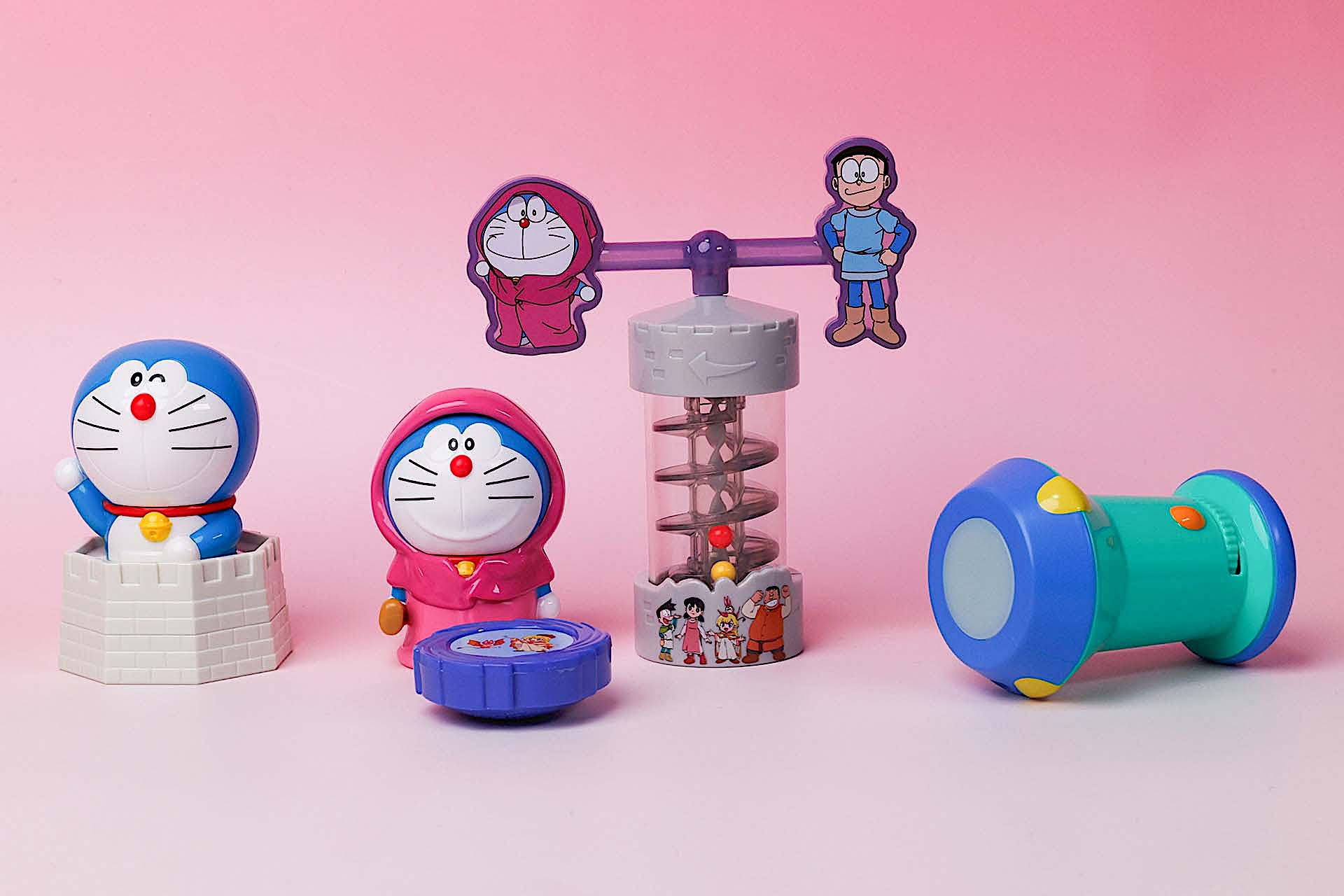 こちらが第1弾（3月21日〜3月27日）のハッピーセット「ドラえもん」に登場するおもちゃ。写真左から「おして遊ぼう！ドラえもんのスタンプ」、「くるくる回る！ドラえもんのスピナー」、「のぼっておりて！ドラえもんのビーズタワー」、「のぞいてみよう！はいりこみライトのビューワー」