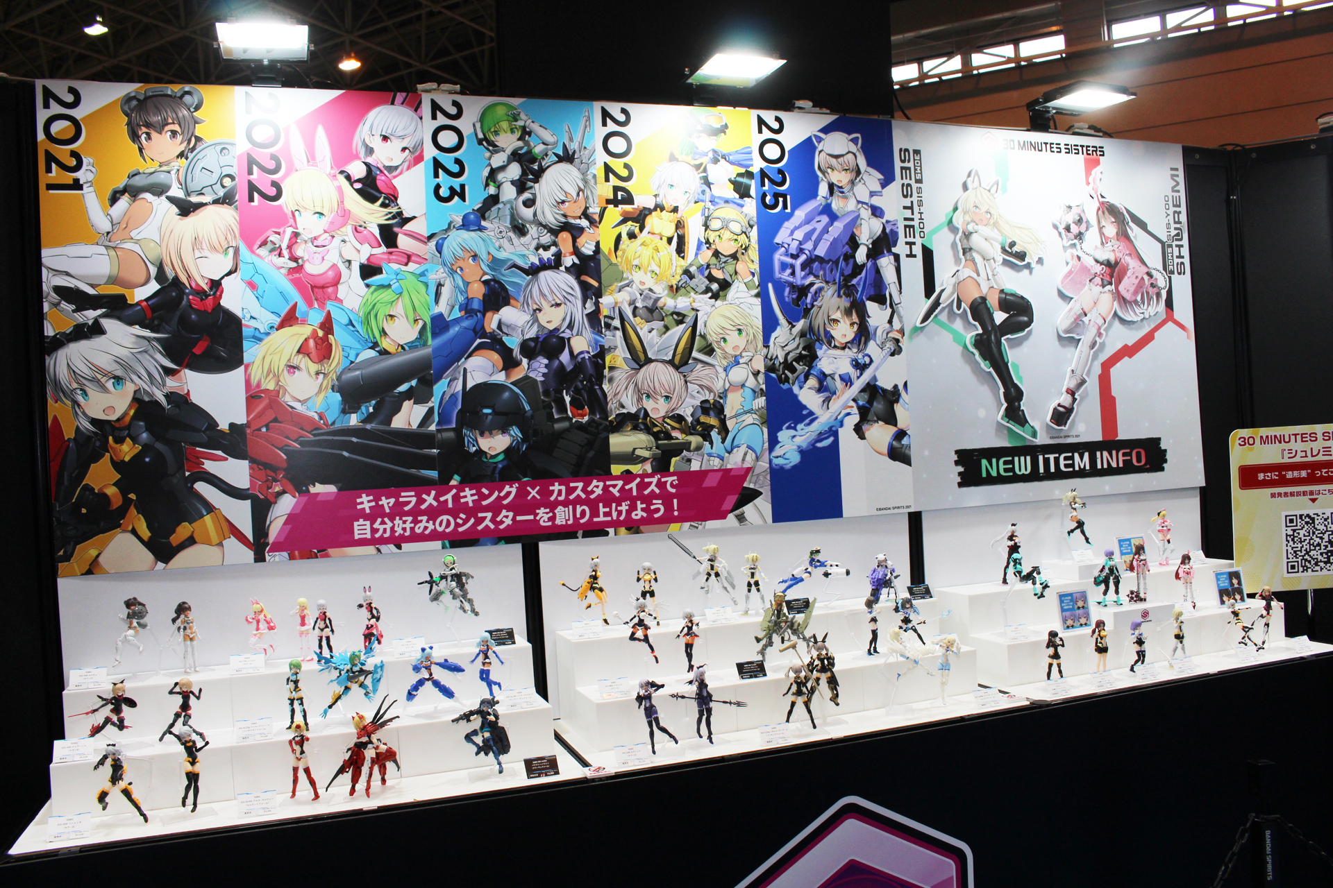 BANDAI SPIRITSブースの30MS展示コーナー。シリーズの5年をフィーチャーした背景に、パーツやコラボを覗く全てのシスターが飾られている