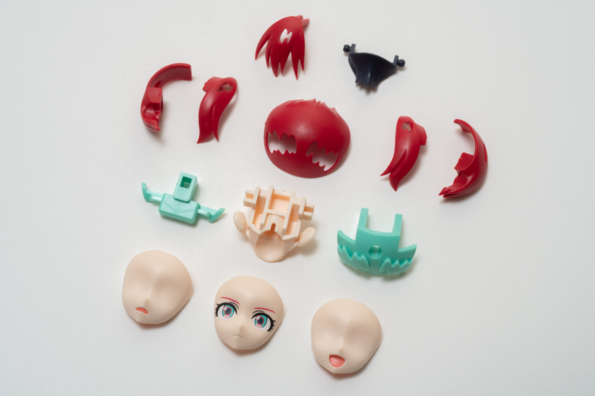 頭部パーツ全景。赤い髪に青のハイライトを埋め込む造りになっている。