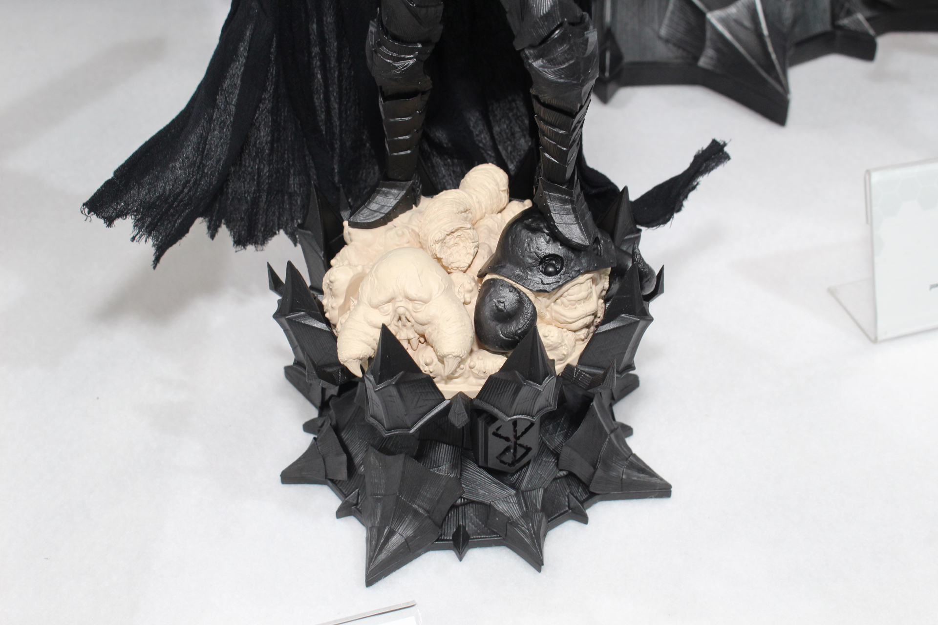 これは素組みの状態。兜の目は塗装済みで、発光表現に生かせるクリアパーツも付属。顔や台座などは成形色で再現している。マントは布製だ