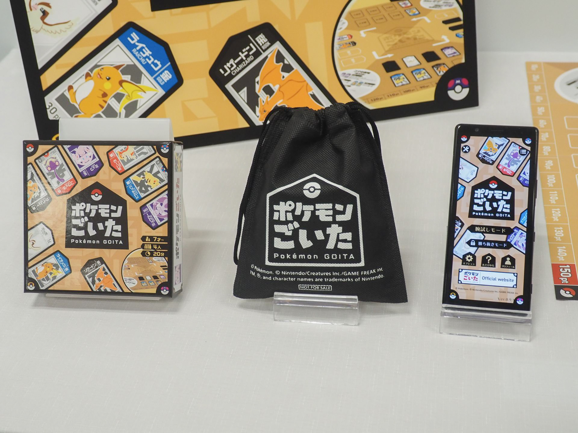 左から「ポケモンごいた」、早期購入特典としてプレゼントされる巾着、無料ティーチングアプリ