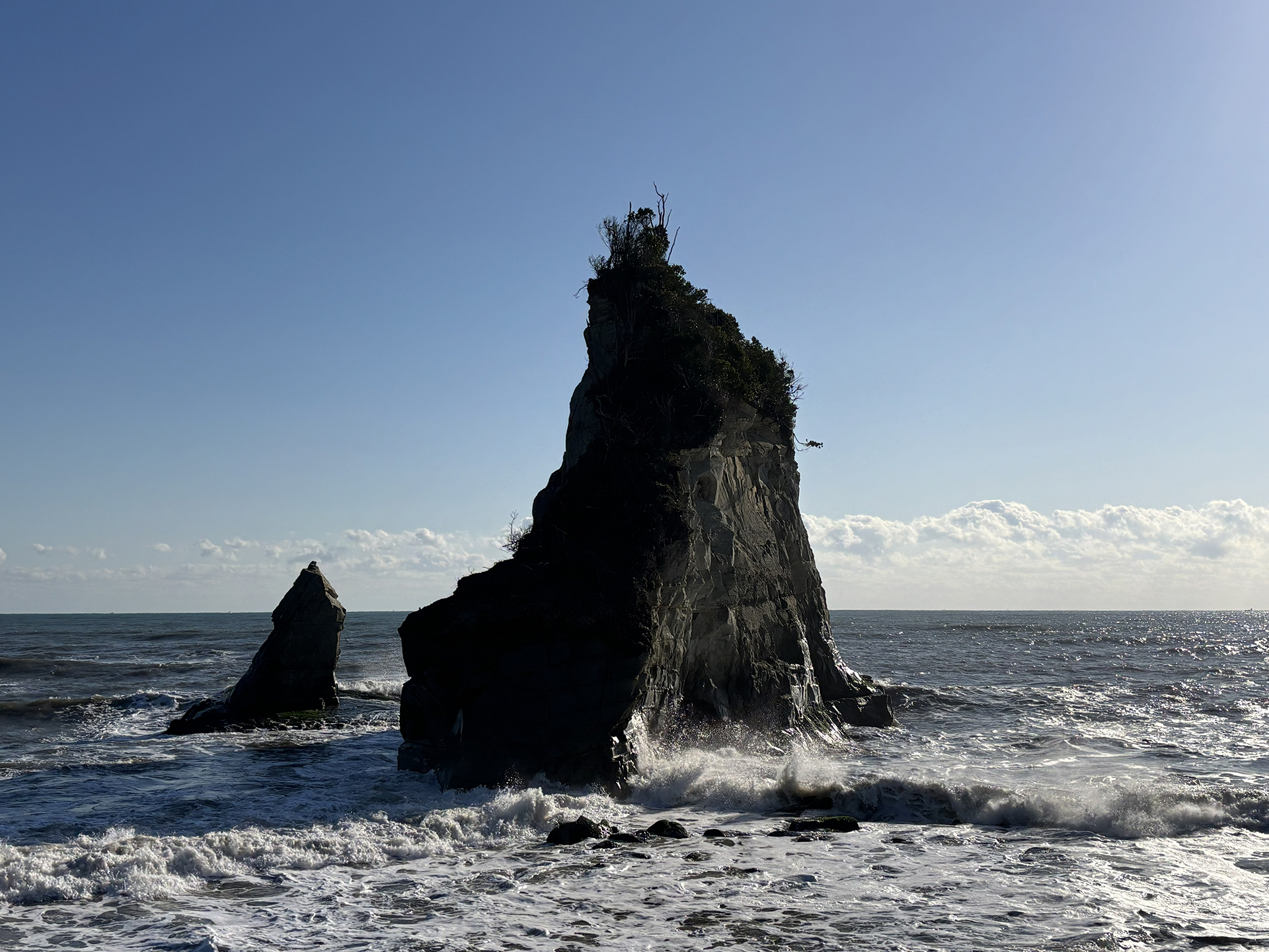 今回、2026年3月での夫婦岩の姿。びっくりするほど形が変わってしまった。他の写真と比べると左側半分がごっそりなくなっているのがわかるだろう。左のもう1つの島のように見えるのは、崩れた島の残った部分なのだ。今では右側の島とで3つの島があるようにも見える