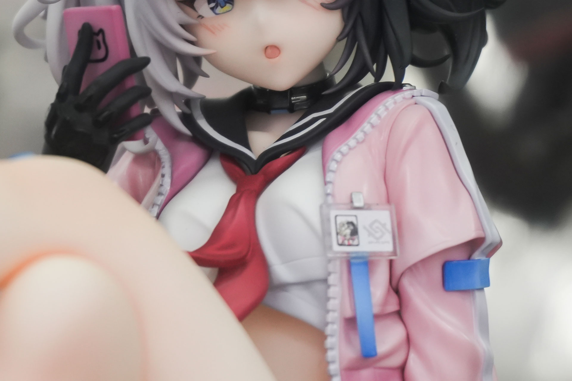 淡いピンクを基調にしたショートジャケットを着用