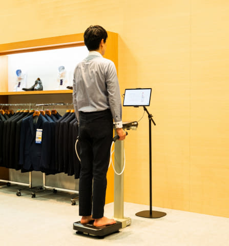 タニタとはるやま、体組成計に乗るだけでスーツサイズ提案
