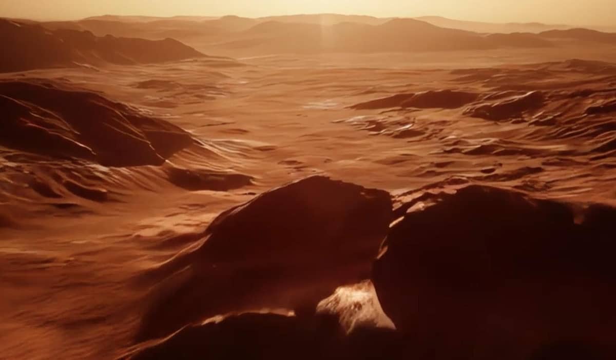 プロンプト：広大な赤い火星の上を飛ぶ、シネマティックなドローンショット。陽が昇り始め、地平線が赤く染まる中、風景が眼下を高速で駆け抜けていく。ショットの終わりには、太陽が地平線から顔を出す。