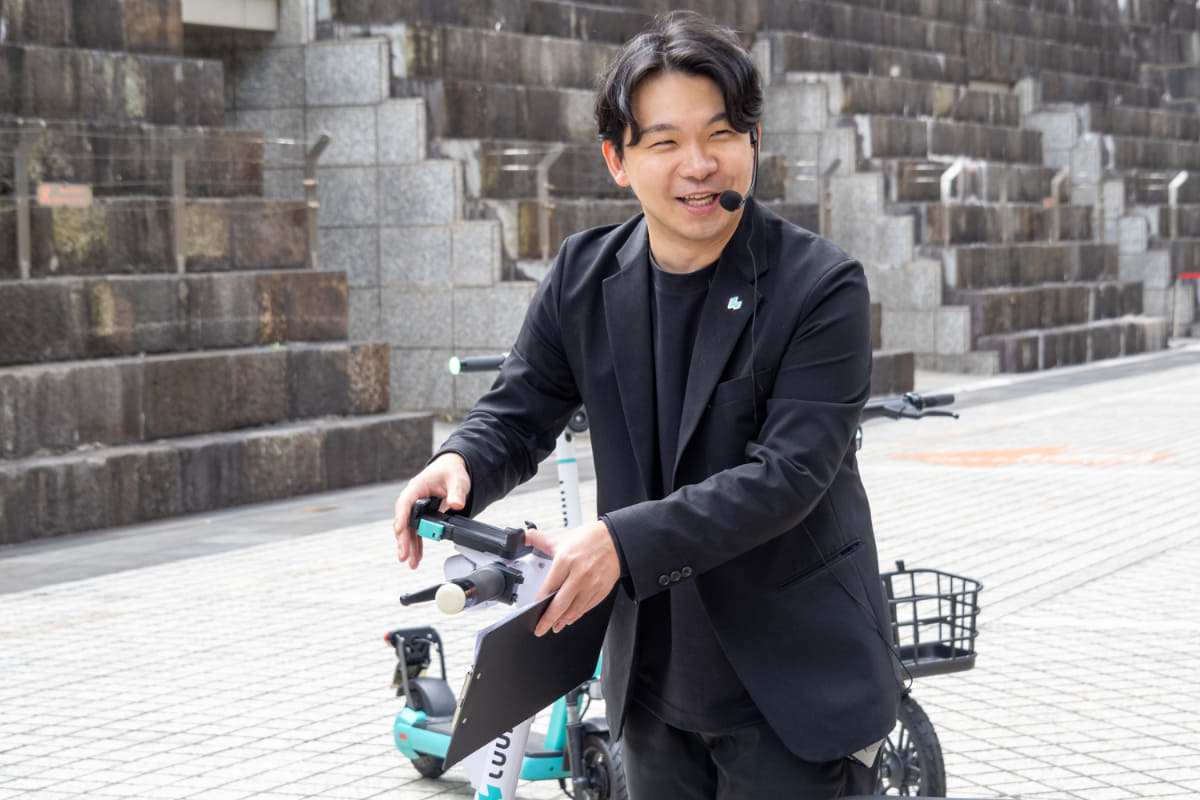 スマホホルダーを紹介する岡井氏