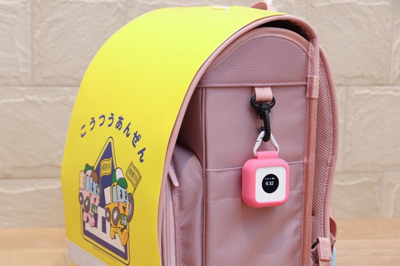 ランドセルの横につけて時計として使うことも。普段は消えているが軽くタッチすると表示される