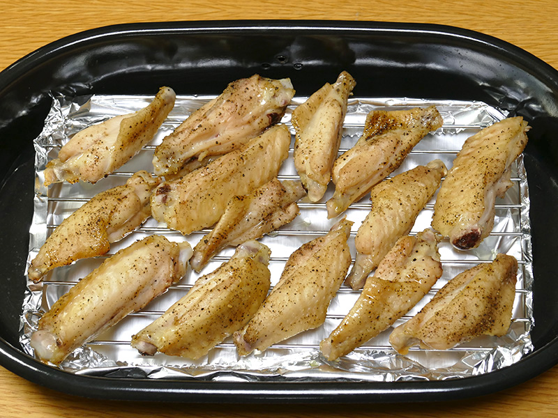 粗熱をとった下焼きした手羽中をくんせい網に並べてからホイルでふたをする