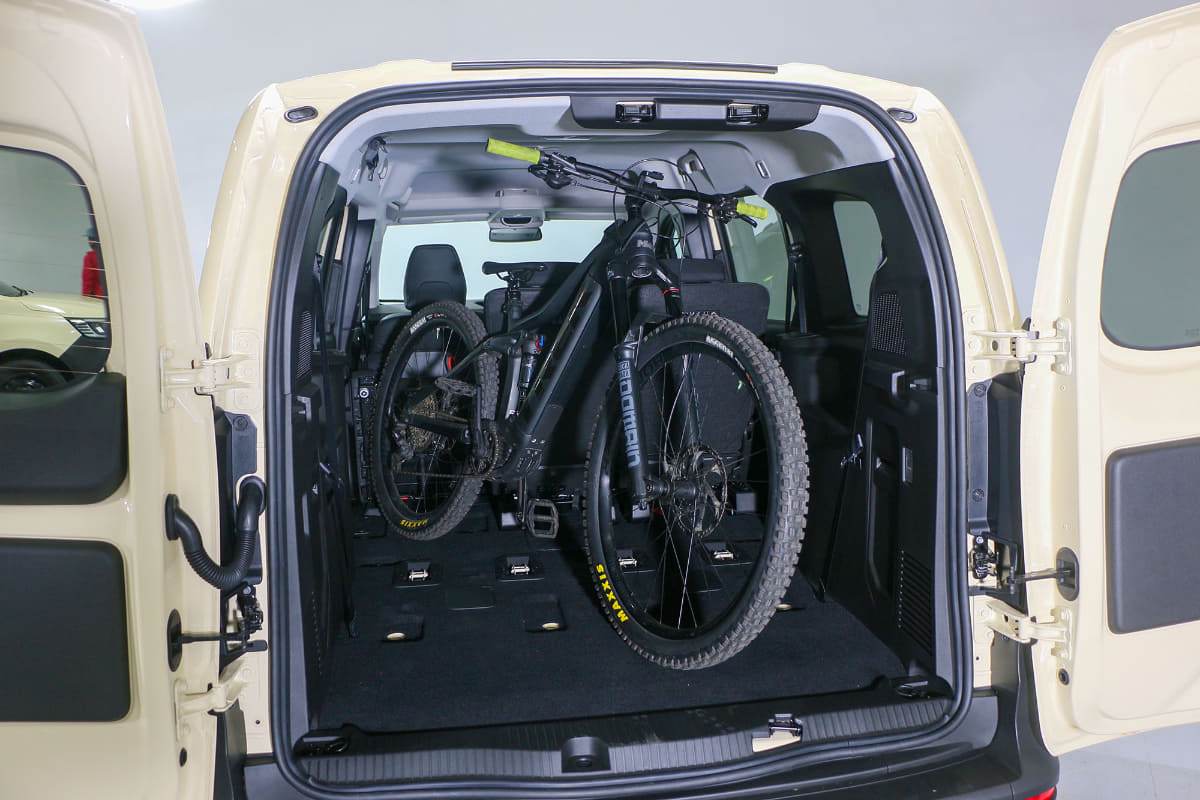 左側のシートをたたみ、そこにリアタイヤを入れる簡単な積載。これなら4人乗車が可能