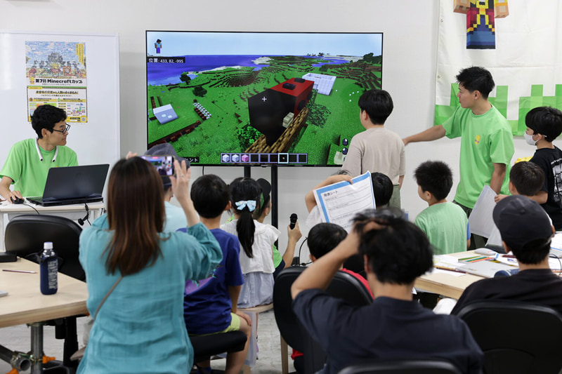 特定非営利活動法人デジタルものづくり協議会が、教育ワークショップ「マイクラでデジタル御輿をつくろう！」の成果展示を2025年11月21日（金）から公開