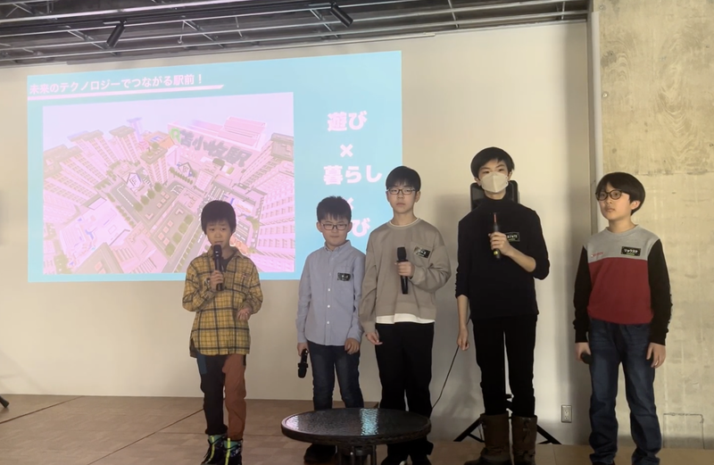 前回大会で、自ら作ったマイクラの街を市長へ熱心にプレゼンする小学生（写真は2026年2月開催時のもの）