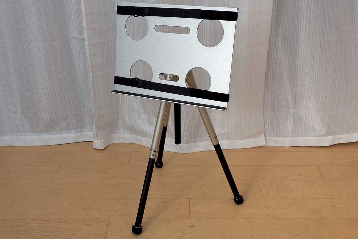 三脚にセットした様子。ある程度頑丈な三脚＋雲台になら、かなり強固に固定できます。斜めにすれば譜面台のような使い方も可能。