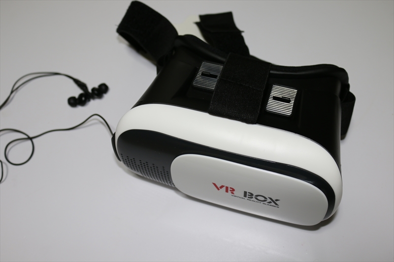 上海問屋の3D VRゴーグル。店頭価格はジャスト500円！　Qua phone PXとイヤホンを装着しているところ