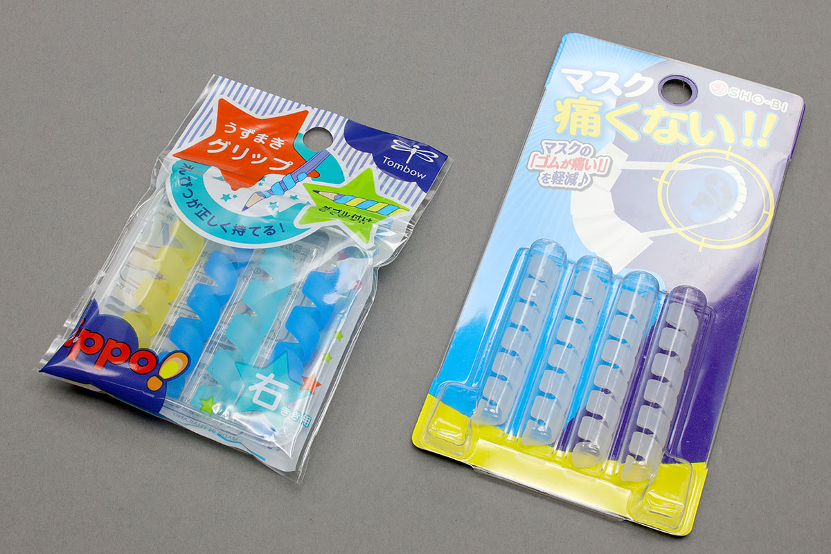 トンボの「ippo! うずまきグリップ」（<a href="http://www.tombow.com/products/uzumaki_grip/" class="n" target="_blank">公式ページ</a>）とSHO-BIの「マスク痛くない！」。前者は鉛筆に巻き付けて使う「鉛筆を正しく持つための補助具」で、後者はマスクの紐に巻いて使う「耳が痛くならないグッズ」です。どちらもスパイラル状のシリコンです。