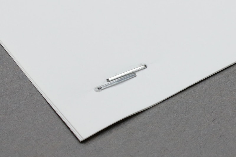 綴じ方はフラットクリンチですが、綴じ裏の針が互い違いになり重ならない独自の「バイパス形状フラットとじ」です。このため、少ない枚数（左）でも多い枚数（右）でも、綴じた部分が同様に薄くなり嵩張りにくく、紙の枚数に応じて針交換する手間もありません。また、少ない枚数を綴じた場合、綴じ裏のステープルが並ぶために綴じ部がより強固になるようです。