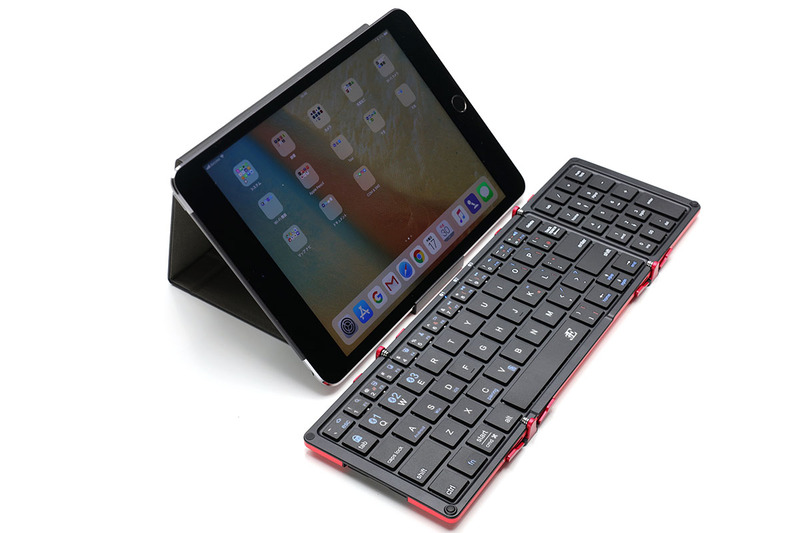 保護ケースはスマートフォンやタブレットのスタンドとしても使えます。下部ストッパーは引き出せて、端末の角度を調節可能。手持ちの端末で試したところ、10.5インチiPad Proや9.7インチiPad、iPad mini、各種iPhoneを、縦向きにでも横向きにでも立てることができました。写真は、中央がiPad mini、右がiPhone 8 Plusを立てた様子です。