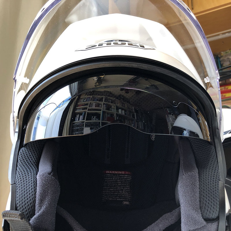 インナーバイザーの出し入れは、だいたいヘルメット左横にあるスライドレバーで行います。インナーバイザーはオデコの上あたりからシュッと出てきます。