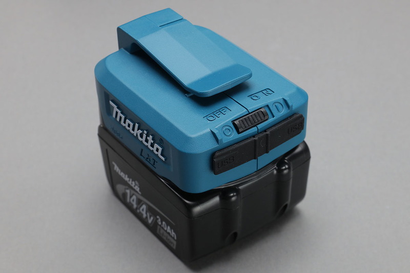 マキタの「ADP05」。マキタの電動工具用14.4V/18V用バッテリーをモバイルバッテリー化するアダプターで、出力は5.0V/2.1A×2。横長の黒い部分が2つの給電用USBポートのカバーです。その上にオンオフスイッチ付き。写真のBL1430バッテリーだと、iPhone6Sを約5回充電できるとのこと。マキタのバッテリーに実用的な付加価値がもたらされてイイ感じですよね～♪　ただし、モバイルバッテリーとしてはゴロリと嵩張り少々重いので、バッグに入れて携帯という用途にはイマイチ向きません。