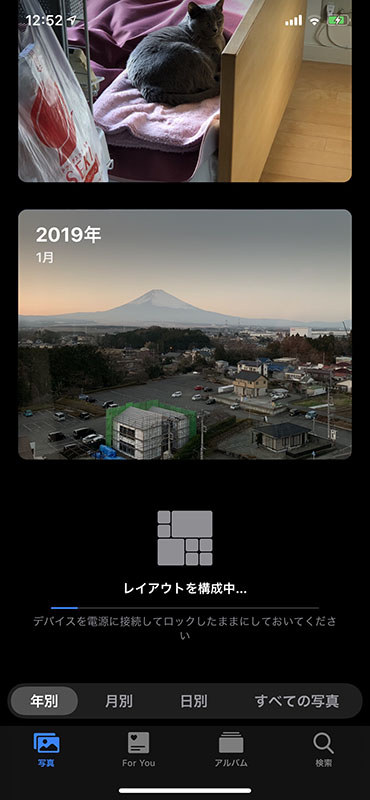 上の写真表示で、日別のみ写真の大小が付いていましたが、これはiOSが自動的に写真を分析・キュレート・レイアウトして表示してくれるためです。上のスクリーンショットはその処理が行わている様子です。結果、似た写真を小さく表示したり特徴的な写真の一部分を大きく表示するようになります。目的の写真を探しやすくなるという印象。