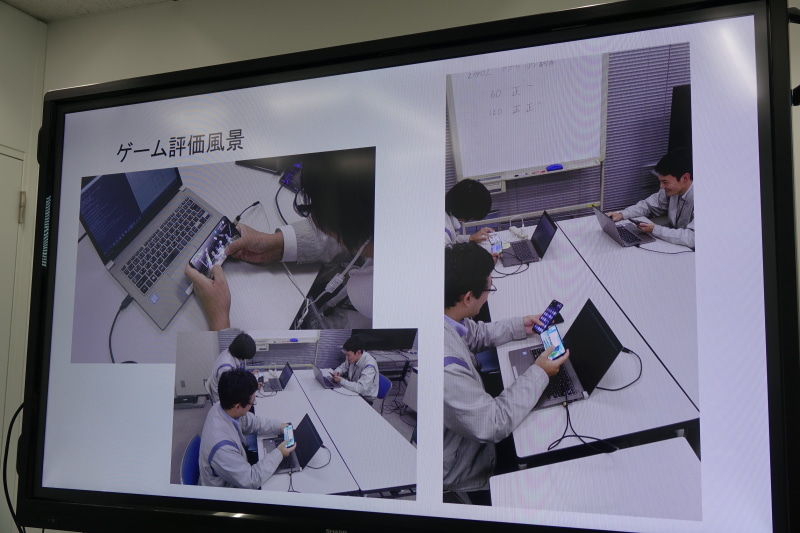 実際に社員がゲームをプレイして検証。右上のホワイトボードの正の字は60、120Hzで動作したゲーム本数の数