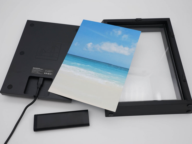 バラすとこんな感じ。左の充電ユニットと右のフレームで写真を挟み込む。写真はちょうど2Lサイズなのでコンビニなどで100円くらいで印刷できる