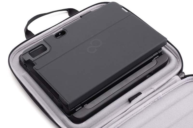 LAN付軽量スリムキーボードと合体したタブレットPCを置くと、バッグ内部のエッジ的凸凹にピッタリとはまった。このまま閉じると、バッグ内部でPCが固定的かつ安定的に保持される。とは言っても若干の余裕があるケースなので、さらにフォリオケースを入れても収まった。そこにさらに専用ACアダプターを隙間に入れても収めることができた。