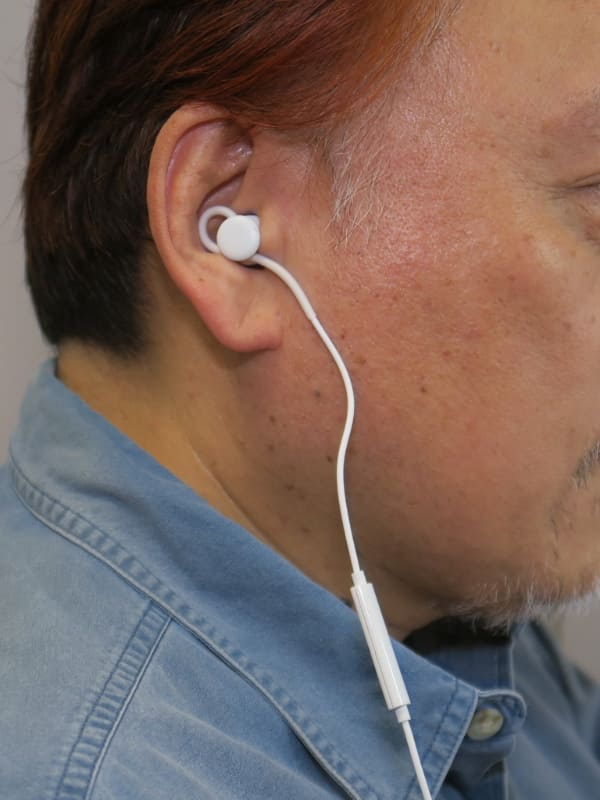 耳に装着したところ。マイク部分は右側