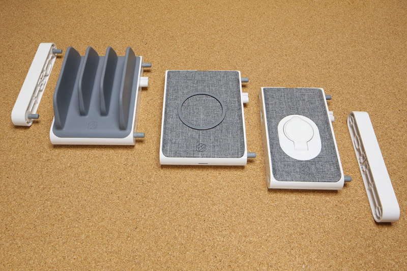 左右端にあるのは末端保護用のエンドキャップ。中央に並ぶ3つのモジュールは、左からタブレット向け充電モジュールの垂直充電ステーション、Qi対応充電モジュールのワイヤレス充電パッド、Apple Watch用充電モジュールのApple Watch用磁気チャージャ。各モジュールは手でグイッと引っ張ると外れて分離できる。グイッと押せば合体