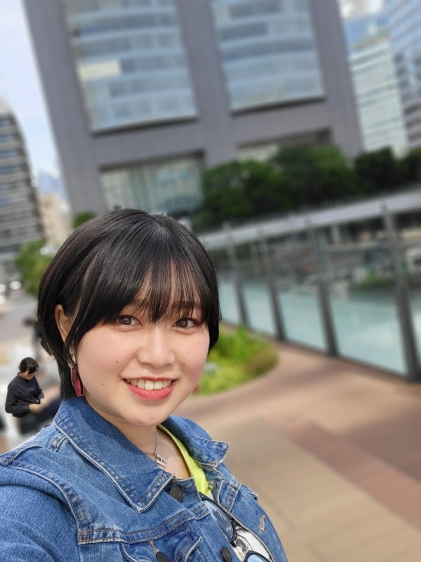 インカメラでセルフィー。オートフォーカスが効き、ポートレートで背景がボケるため、かなりくっきりした写真が撮影できる。本人の左後ろの人物がボケていないのはご愛敬（笑）