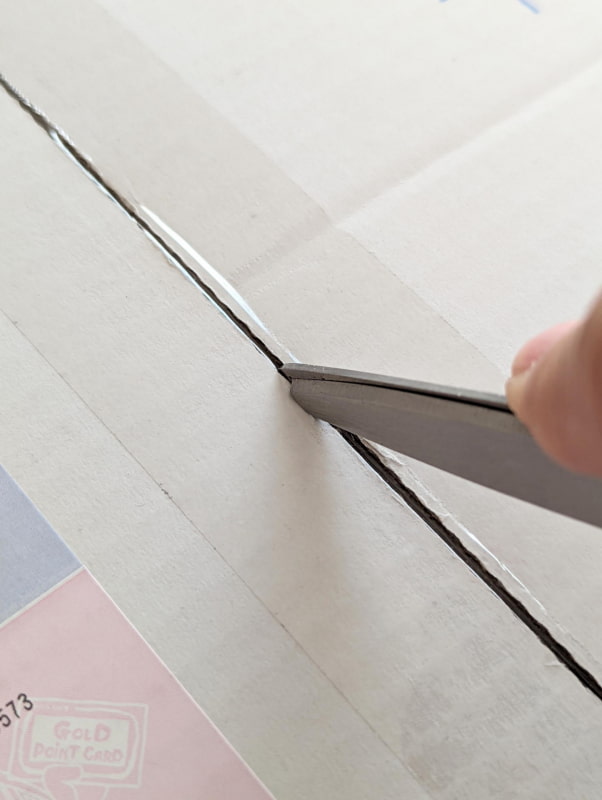 両刃の長さが敢えて揃っておらず、飛び出した長い方の刃でテープを切る