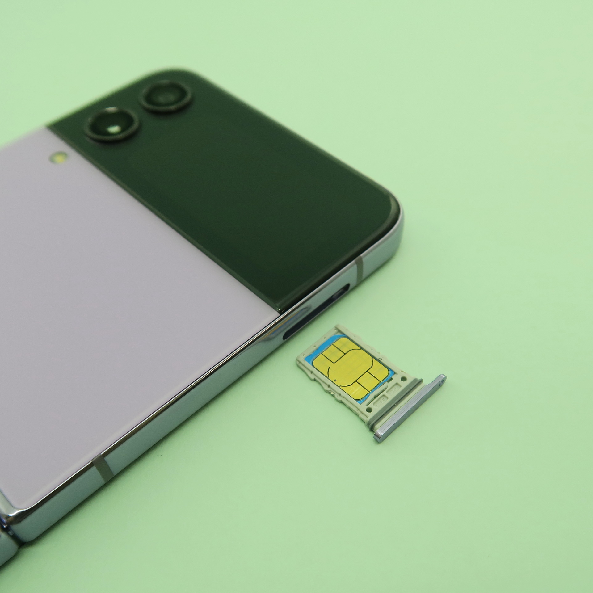 「Galaxy Z Flip4」の上側の筐体にピンで取出すタイプのSIMカードトレイを備える。SIMカードは1枚のみ装着が可能。デュアルSIMを利用したいときはeSIMを追加する