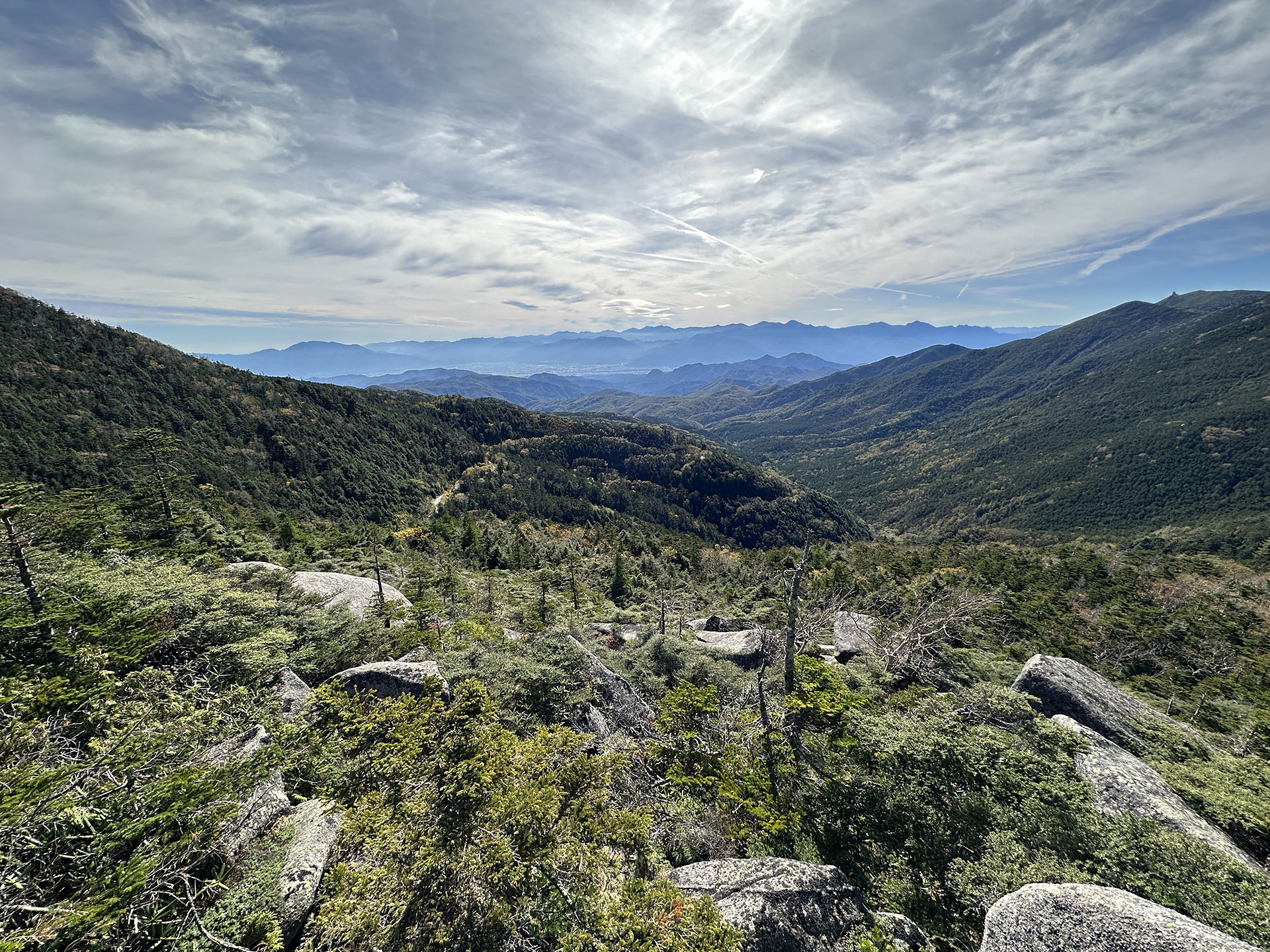高所から超広角（0.5x/13mm）で撮影。やや逆光で明るい空を入れながらの撮影だが、山々も潰れずに描写されている。スマートフォン写真のなかでは発色も抑え気味のように感じる。いやーしかしかなり鮮明な印象の写真が撮れるようになった。