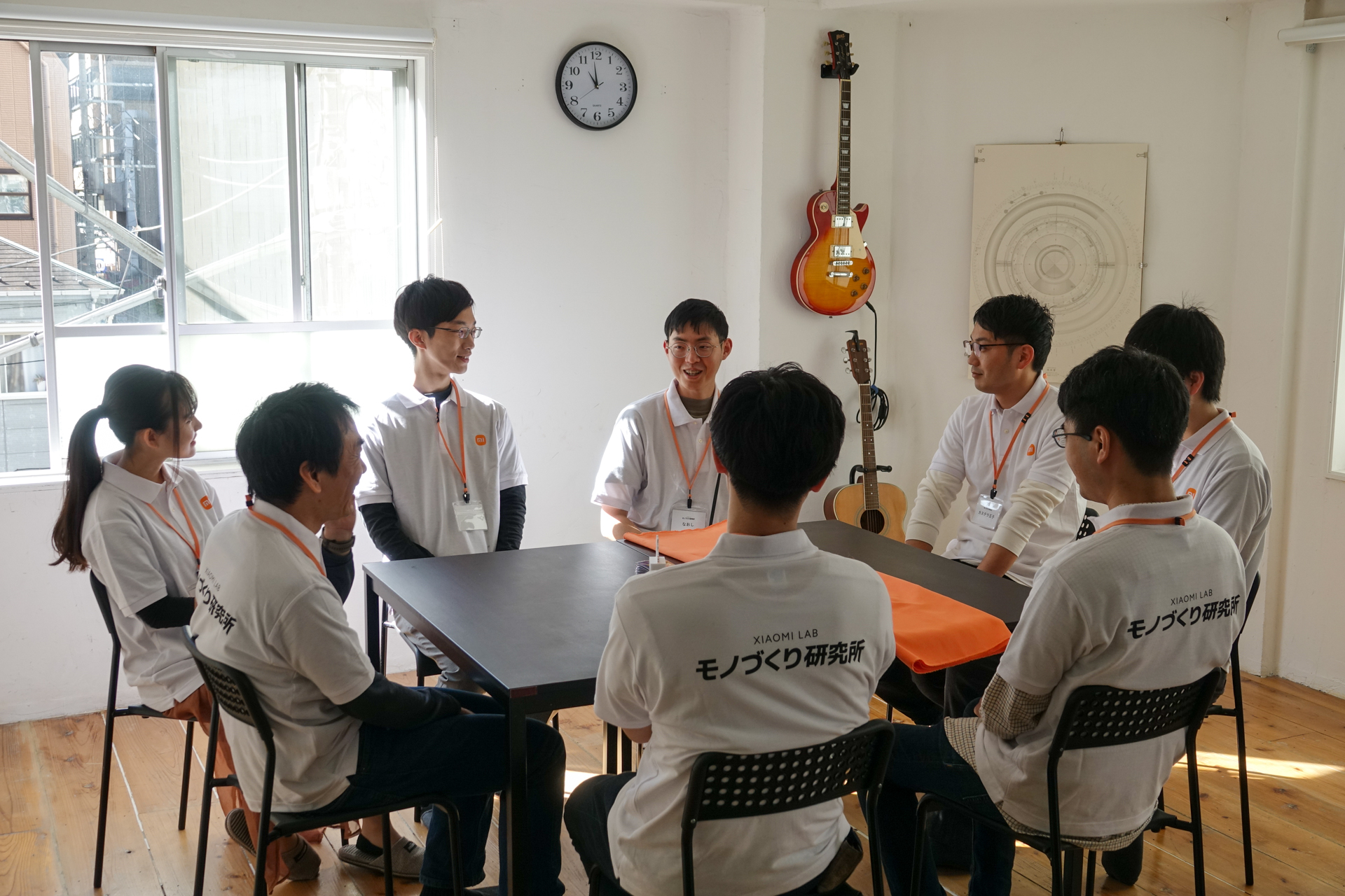 「Xiaomi 12T Pro」お披露目前の談笑タイム。机上のオレンジ色のシートの下に実機が隠されている