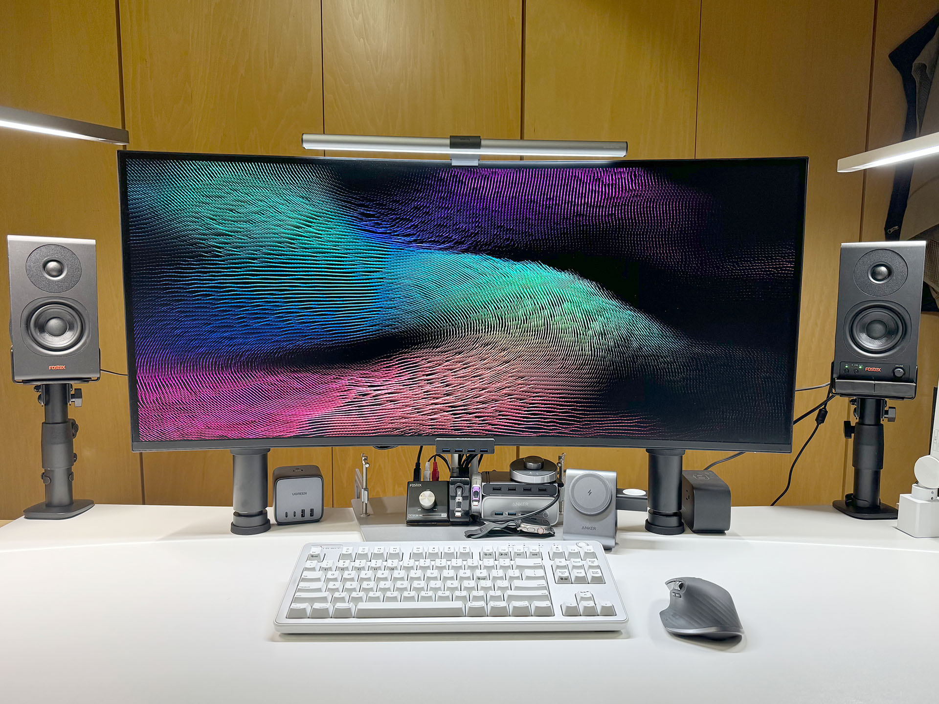 デスクトップPCのディスプレイがある机の左右に設置。クランプ式のスピーカースタンドの上に置いている。