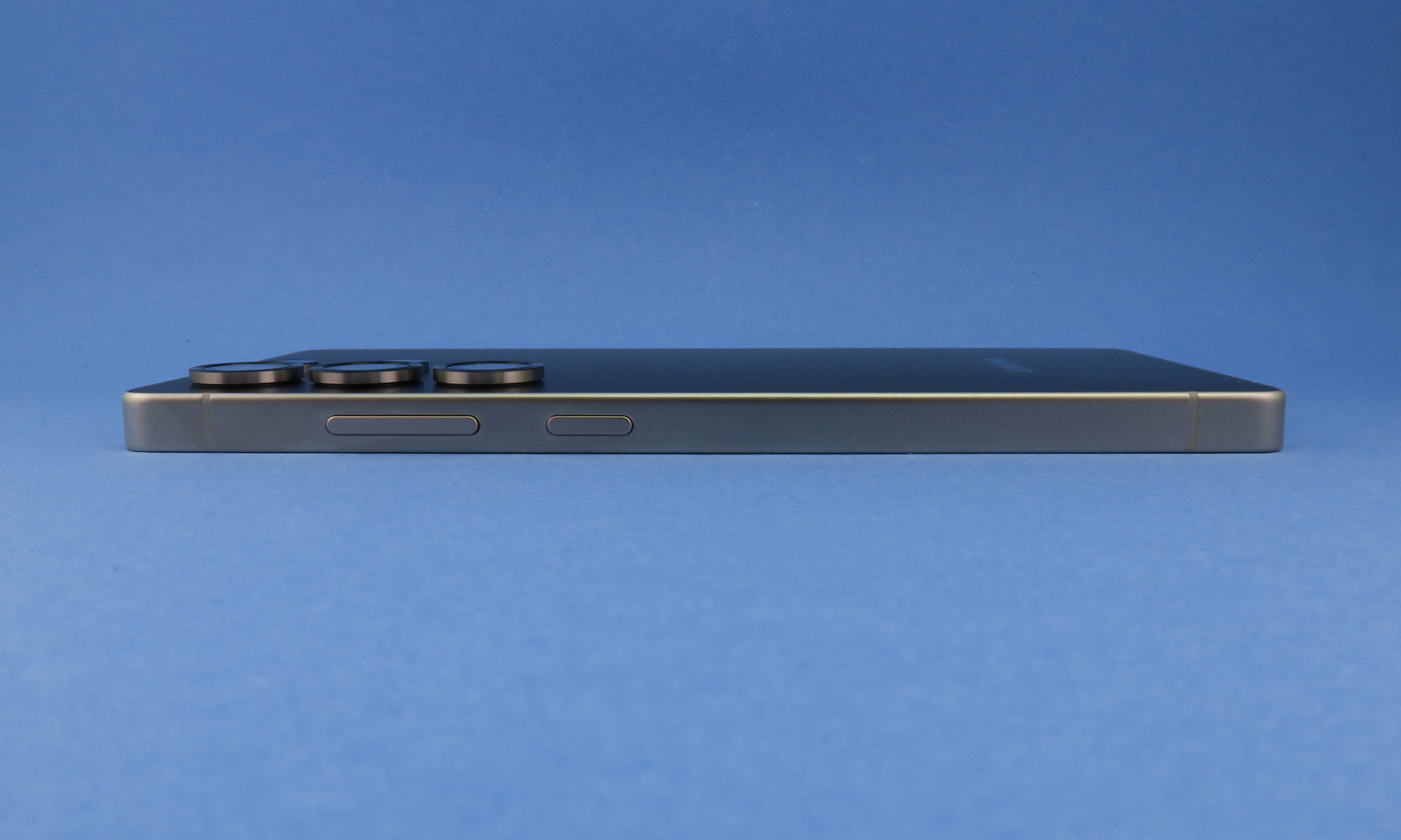 「Galaxy S25」の右側面は上部側（写真左側）にシーソー式音量キー、隣に電源ボタンを備える。カメラ部の突起は約2.3mm
