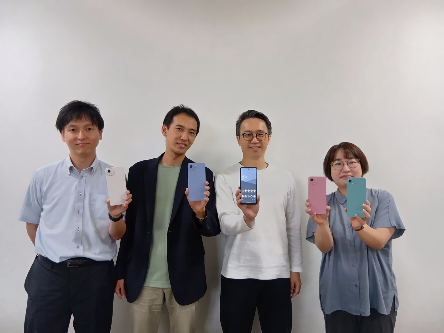 シャープ広島事業所より参加メンバー：写真左からシャープ株式会社 通信事業本部 パーソナル通信事業部　回路開発部 課長　木村 正和氏、商品企画部 係長 今井 啓介氏、同 課長 大川 喬弘氏、第一ソフト開発部 技師 岩井 亜理沙氏、写真には写っていないが、シャープ幕張事業所より参加：通信事業本部 デザインスタジオ デザイナー 横山 輝氏